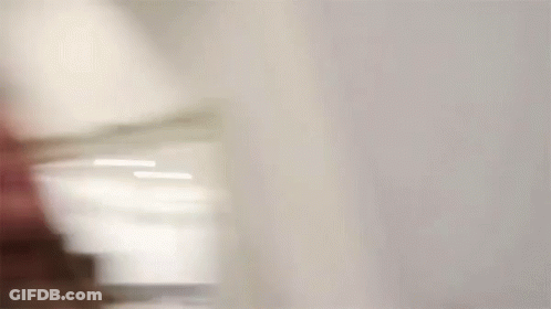 A Blurry Picture Of A Woman Drinking From A Glass . GIF