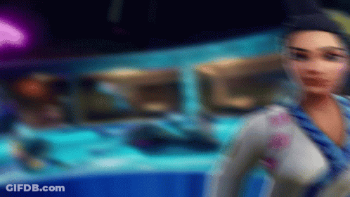 A Blurry Picture Of A Woman In A Blue And White Outfit GIF