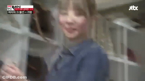 A Blurry Picture Of A Woman In A Blue Shirt Standing In A Kitchen . GIF