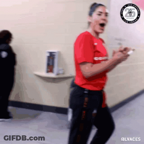 A Blurry Picture Of A Woman In A Red Shirt And Black Pants With The Hashtag @Lvaches GIF