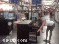 A Blurry Picture Of A Woman In A Store Looking At A Table GIF