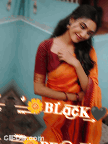 A Blurry Picture Of A Woman In An Orange Saree With The Word Black Written On It GIF