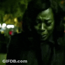 A Blurry Picture Of A Woman 'S Face In A Dark Room GIF