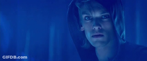 A Blurry Picture Of A Woman 'S Face With Blue Lights In The Background GIF