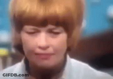 A Blurry Picture Of A Woman 'S Face With Her Eyes Closed . GIF
