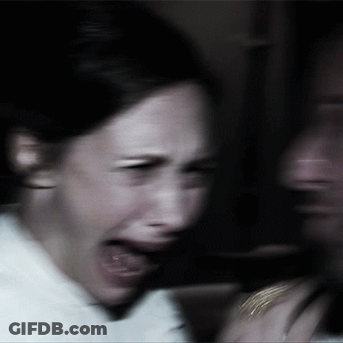 A Blurry Picture Of A Woman Screaming With Her Mouth Wide Open GIF