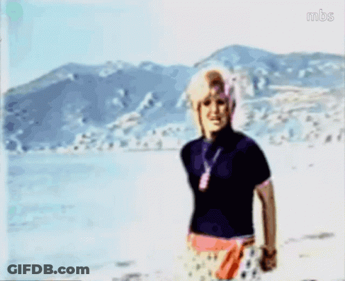 A Blurry Picture Of A Woman Standing On A Beach With Mbs Written On The Bottom Right GIF