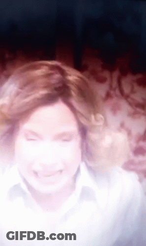 A Blurry Picture Of A Woman With Her Eyes Closed And Her Hair Blowing In The Wind GIF