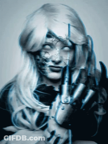 A Blurry Picture Of A Woman With White Eyes Holding A Claw GIF