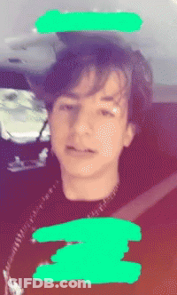 A Blurry Picture Of A Young Boy With A Green Circle Around His Head GIF