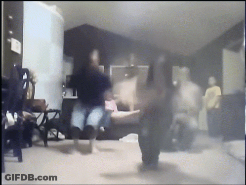 A Blurry Picture Of People Dancing In A Room GIF