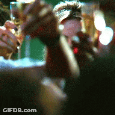A Blurry Picture Of People Holding Glasses Of Champagne GIF