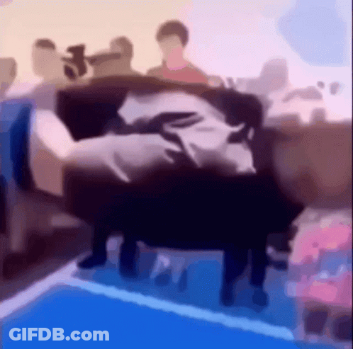 A Blurry Picture Of People Sitting On A Couch In A Room GIF