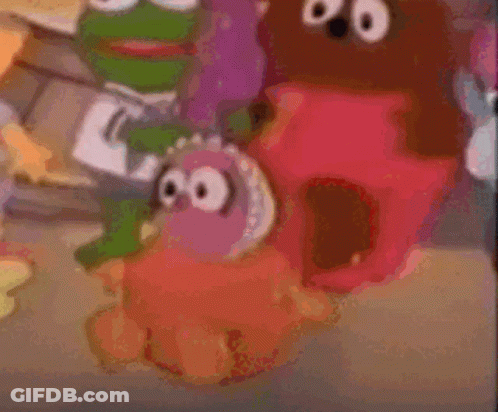 A Blurry Picture Of Sesame Street Characters Including A Frog GIF