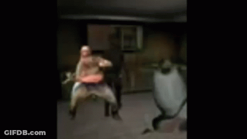 A Blurry Picture Of Three People Dancing In A Room . GIF