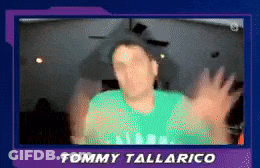 A Blurry Picture Of Tommy Tallarico With His Hands Outstretched GIF