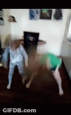 A Blurry Picture Of Two Children Playing With A Dog GIF