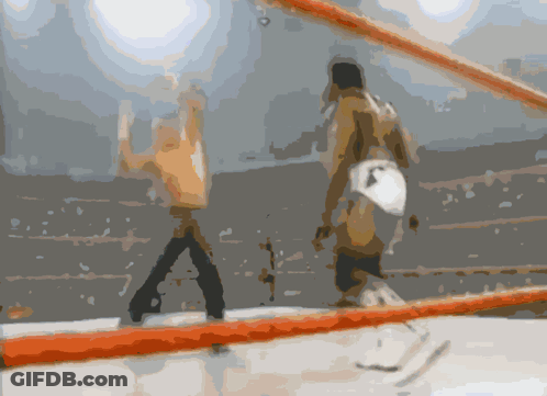 A Blurry Picture Of Two Men In A Boxing Ring With A Red Rope GIF