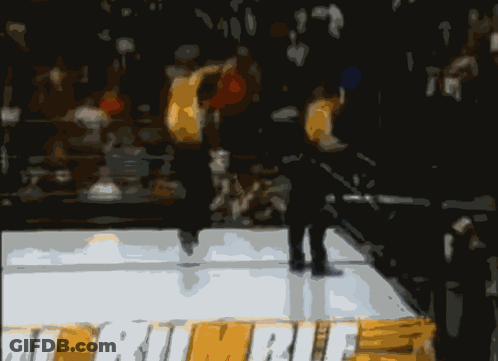 A Blurry Picture Of Two Men In A Boxing Ring With One Wearing A Pair Of White Underwear GIF