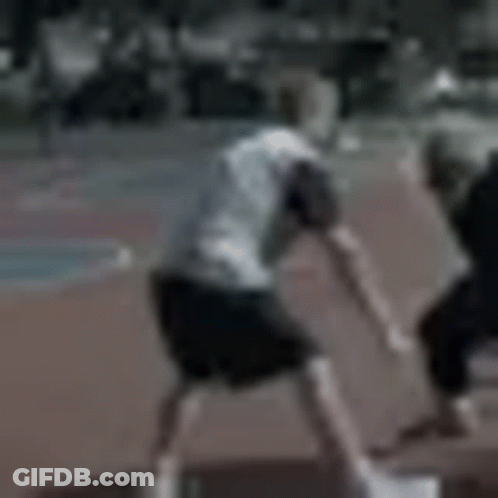 A Blurry Picture Of Two Men Playing Soccer On A Track . GIF