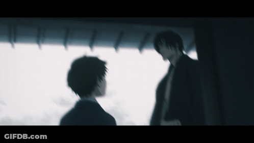 A Blurry Picture Of Two Men Standing In A Dark Room GIF