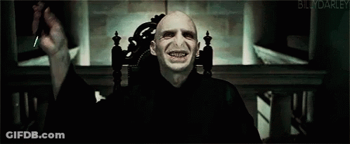 A Blurry Picture Of Voldemort From Harry Potter With A Blue Light Coming Out Of His Eyes GIF