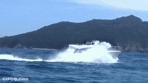 A Boat Is Going Very Fast In The Ocean GIF