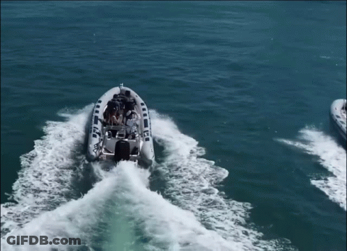 A Boat With A Mercury Motor Is Floating On The Water GIF