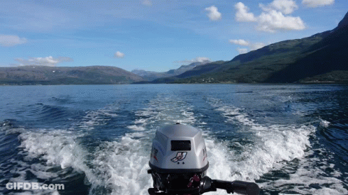 A Boat With A Mercury Outboard Motor Is Going Through A Body Of Water GIF