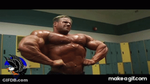 A Bodybuilder Flexes His Muscles In A Locker Room With A Make A Gif.com Logo In The Corner GIF