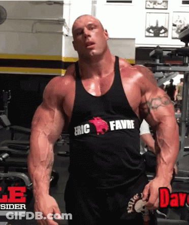 A Bodybuilder Wearing A Black Tank Top That Says Eric Favre On It GIF