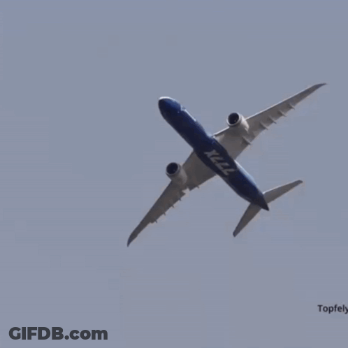 A Boeing X222 Plane Is Flying Through A Clear Blue Sky GIF