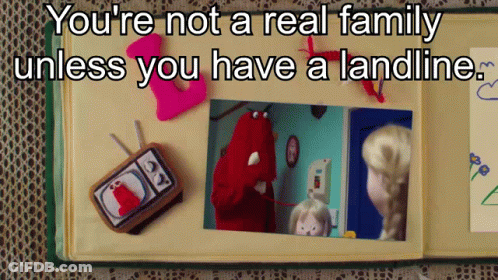 A Book Is Open To A Page That Says You 'Re Not A Real Family Unless You Have A Landline .. GIF