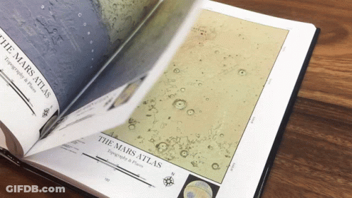 A Book Is Open To A Page Titled " The Mars Atlas " GIF