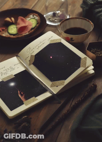 A Book Is Open To A Page With A Fireworks Display GIF