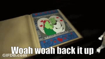 A Book Is Open To A Picture Of Shrek And Fiona GIF