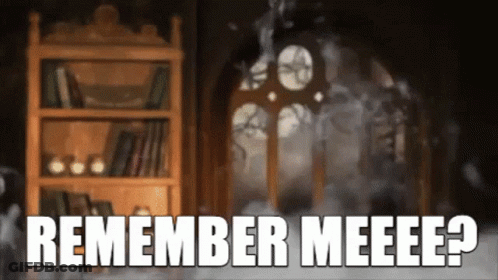 A Bookshelf In A Dark Room With The Words Remember Meeee Written On It GIF