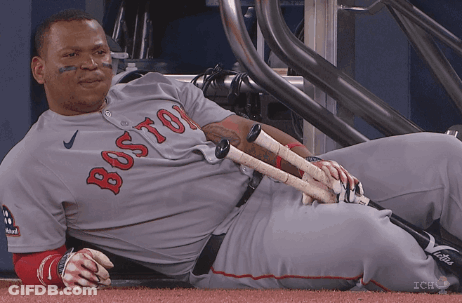 A Boston Baseball Player Laying On The Ground With His Bats GIF