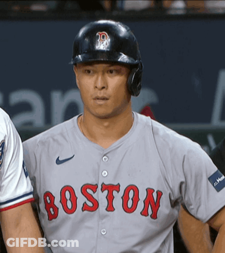 A Boston Baseball Player Wearing A Helmet And A Grey Jersey GIF