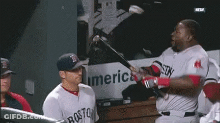 A Boston Red Sox Baseball Player Is Swinging A Bat At Another Player GIF
