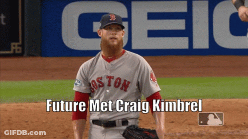 A Boston Red Sox Baseball Player Stands On The Field In Front Of A Geico Banner GIF