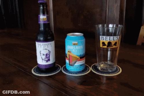 A Bottle Of Bell 'S Beer Sits Next To A Glass And A Can GIF
