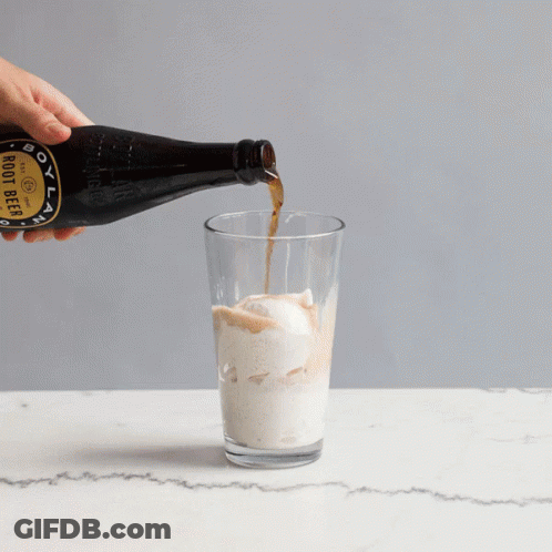 A Bottle Of Boot Beer Is Poured Into A Glass GIF