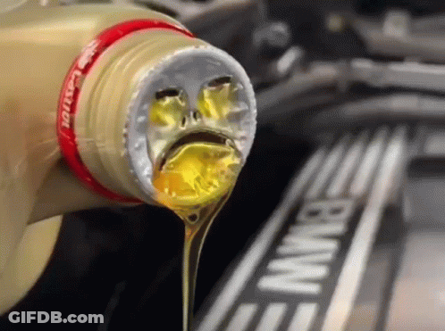 A Bottle Of Castrol Oil Being Poured Into A Bmw Engine GIF