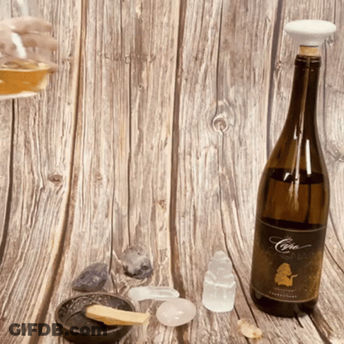 A Bottle Of Chardonnay Sits On A Wooden Surface GIF