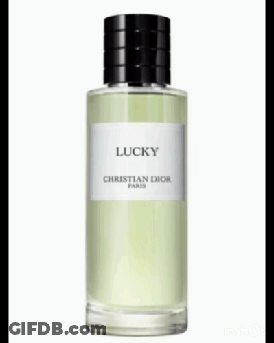 A Bottle Of Christian Dior Lucky Perfume Is Surrounded By Lily Of The Valley Flowers GIF
