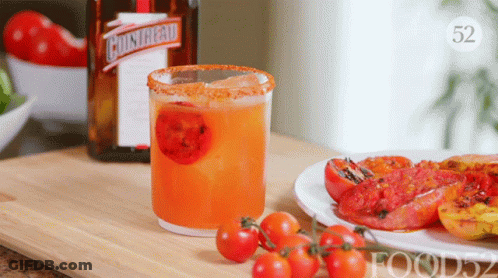 A Bottle Of Cointreau Sits Next To A Drink In A Glass GIF