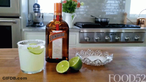 A Bottle Of Cointreau Sits On A Counter Next To A Margarita GIF