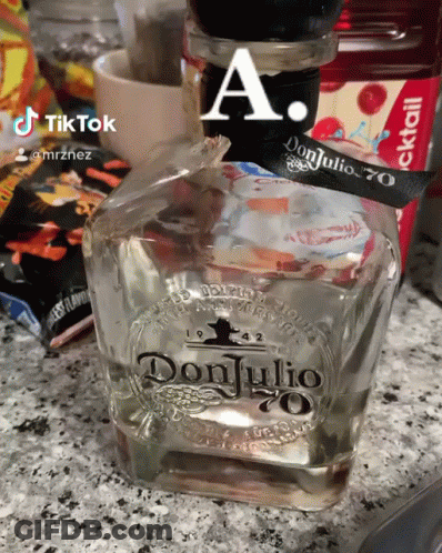 A Bottle Of Don Julio 70 Is Sitting On A Counter GIF