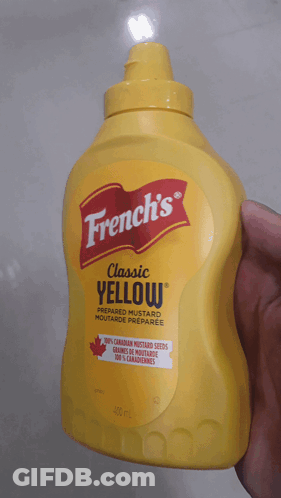 A Bottle Of French 'S Classic Yellow Mustard In A Hand GIF